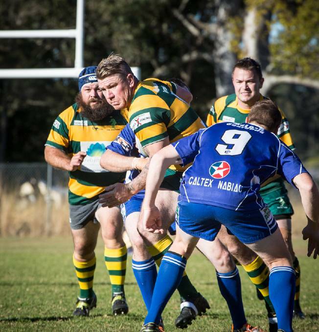 Forster Dolphins and Wallamba Bulls in last year’s Lower Mid North Coast rugby union play-offs. Troy Haines is the powerhouse making the charges.